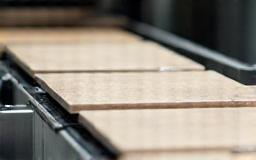 Close-up of tiles being processed on a conveyor belt